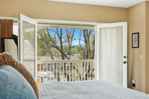 a view of a bedroom with wooden floor and a window