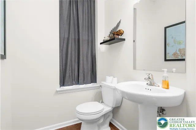 a bathroom with a sink toilet and mirror