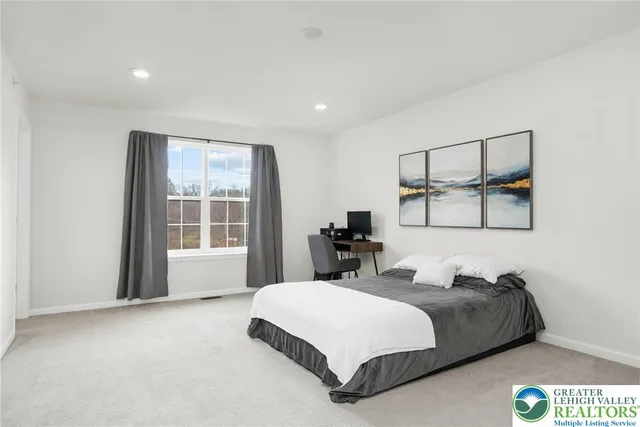 a spacious bedroom with a bed and window