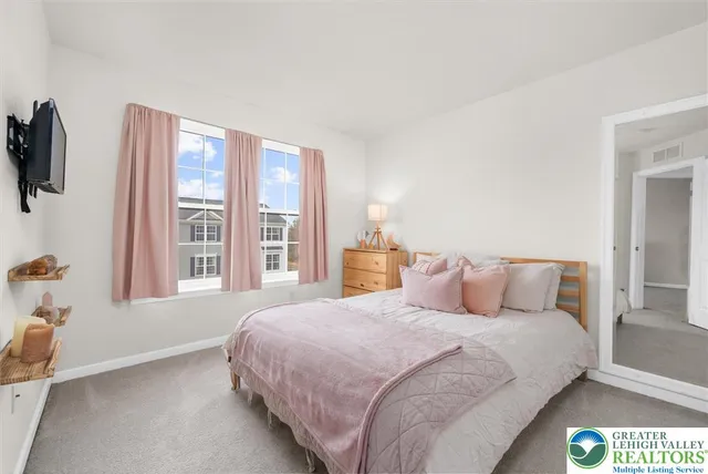 a bedroom with a large bed and a large window