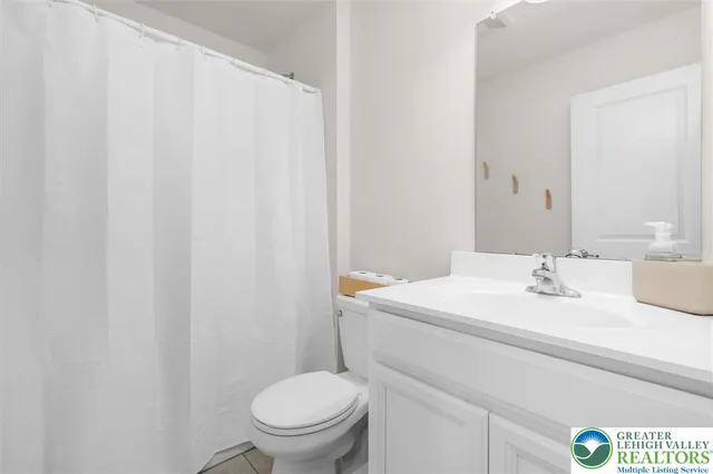 a bathroom with a sink toilet and a mirror