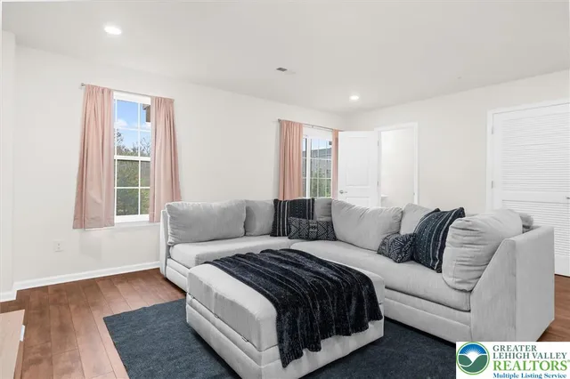 a living room with a bed furniture and a window