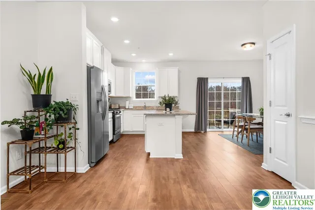 a view of a kitchen with dining table and chairs