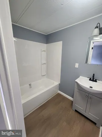 a bathroom with a sink a toilet and bathtub