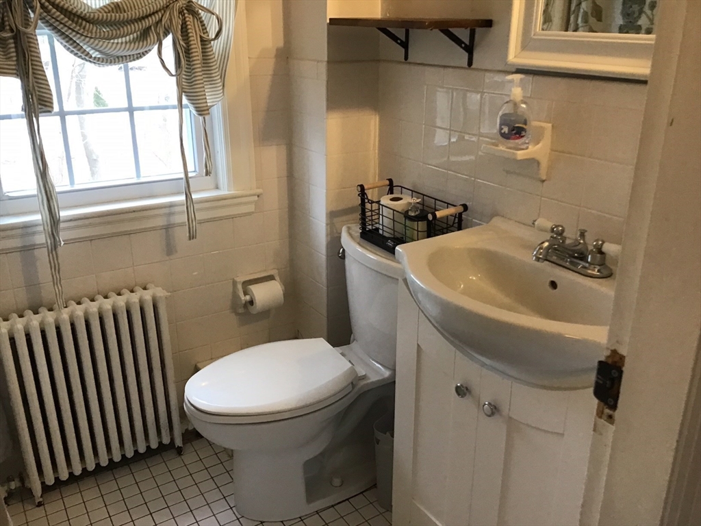 2 Coolidge Road Woburn, MA 01801 - Photo 12 of 24 a bathroom with a sink toilet and window