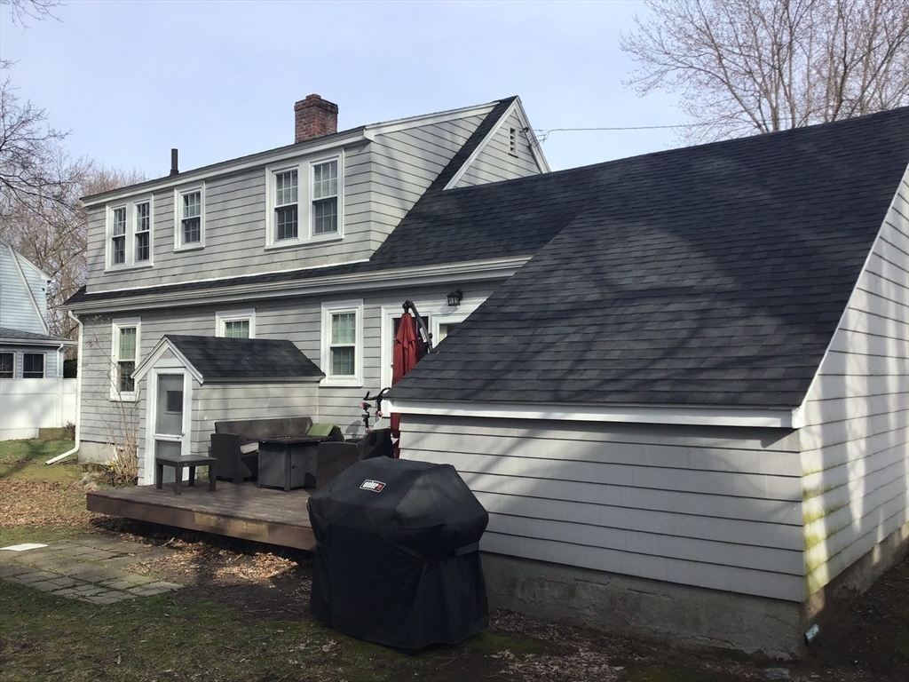 2 Coolidge Road Woburn, MA 01801 - Photo 18 of 24 a front view of a house with a chair