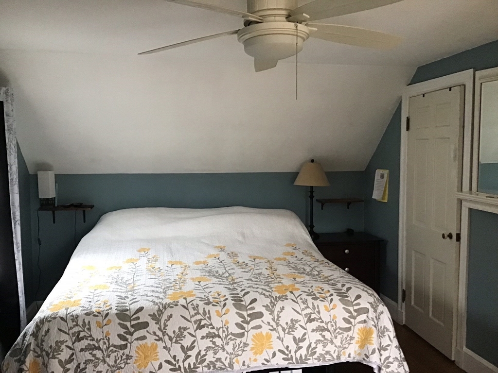 2 Coolidge Road Woburn, MA 01801 - Photo 9 of 24 a bedroom with a bed and a dresser