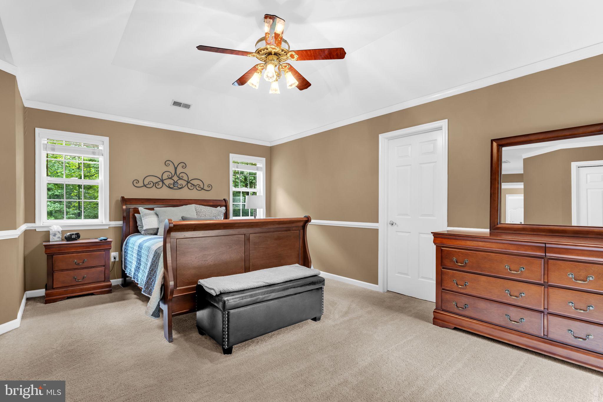 204 Walnut Creek Road Huntingtown, MD 20639 - Photo 23 of 59 a bedroom with a bed and a chandelier