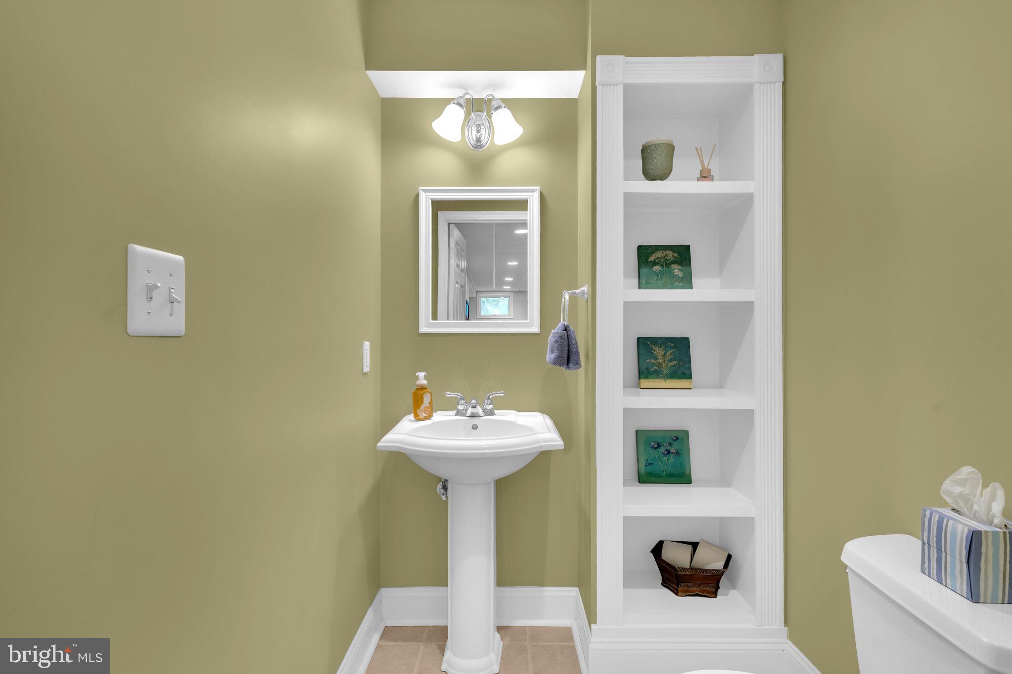 204 Walnut Creek Road Huntingtown, MD 20639 - Photo 42 of 59 a bathroom with a sink and a mirror