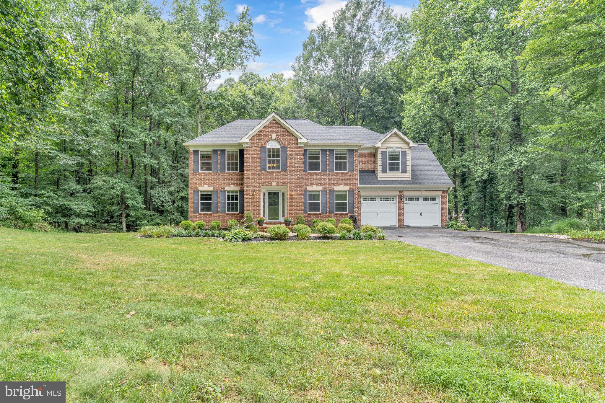204 Walnut Creek Road Huntingtown, MD 20639 - Photo 54 of 59 a front view of a house with a garden