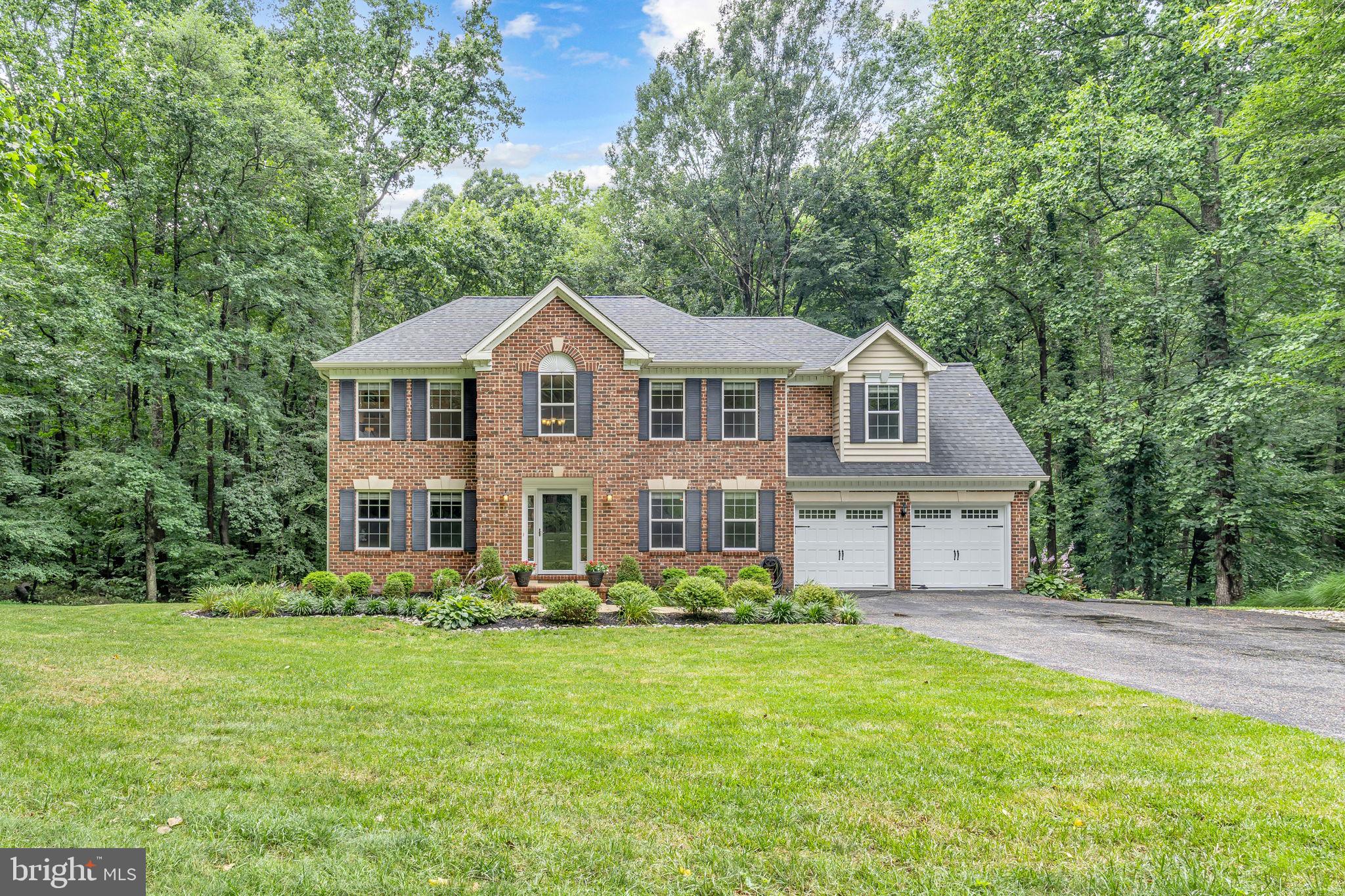 204 Walnut Creek Road Huntingtown, MD 20639 - Photo 6 of 59 a front view of a house with garden