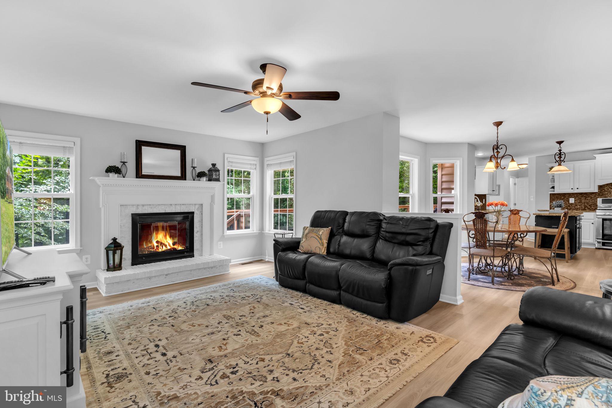 204 Walnut Creek Road Huntingtown, MD 20639 - Photo 8 of 59 a living room with furniture a fireplace and a flat screen tv
