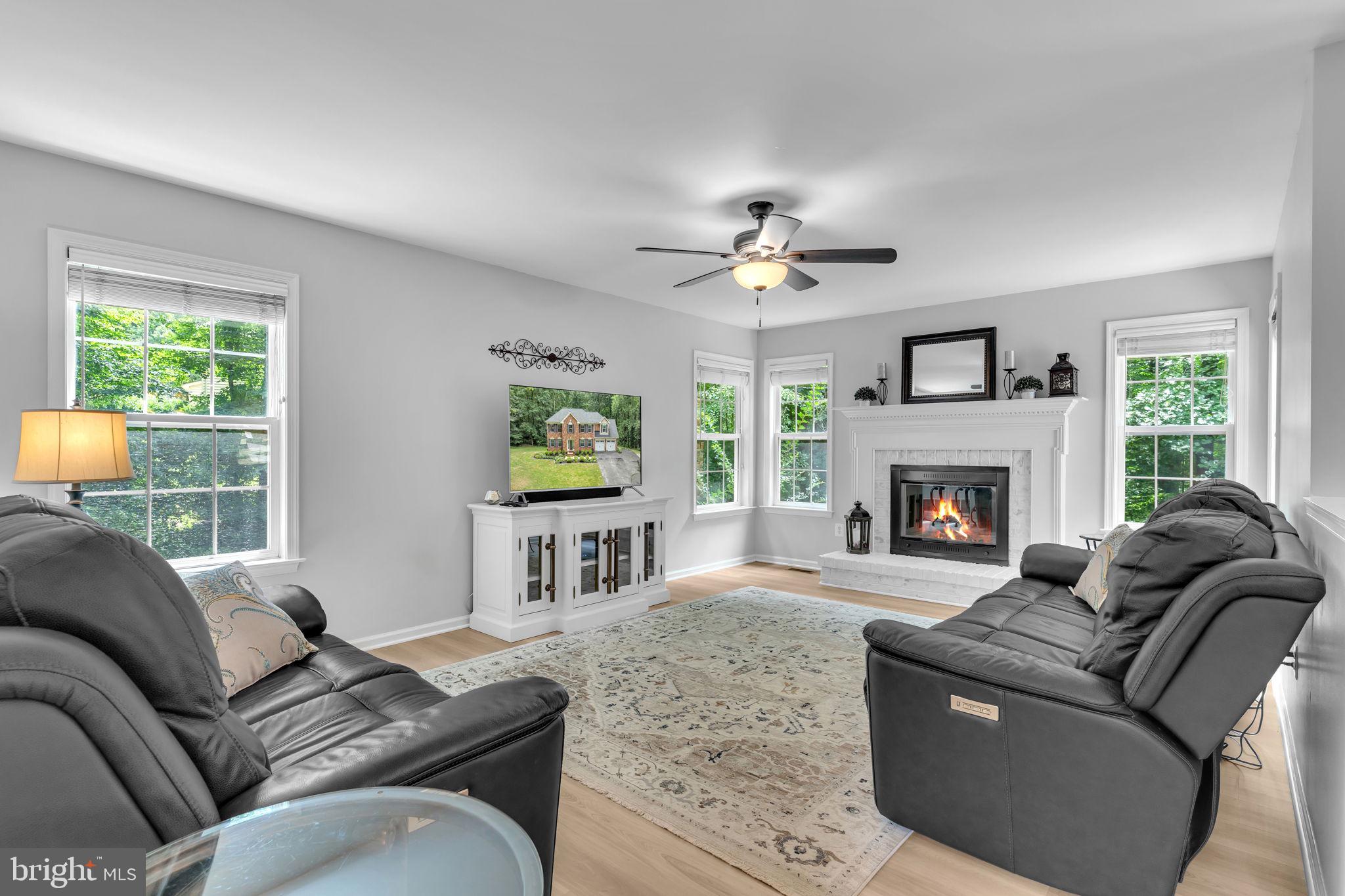 204 Walnut Creek Road Huntingtown, MD 20639 - Photo 9 of 59 a living room with furniture and a fireplace