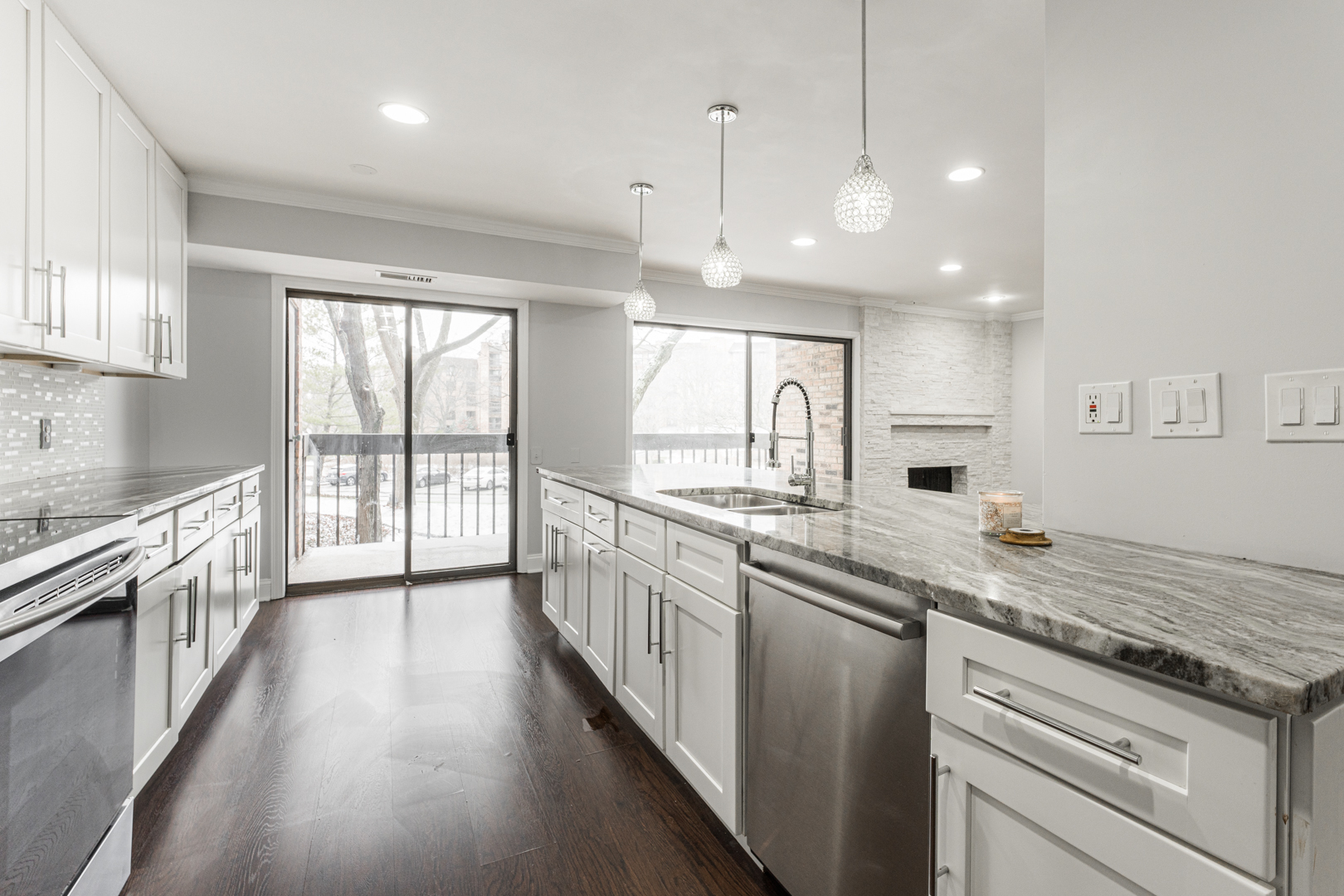 1831 Mission Hills Road, Unit 106 Northbrook, IL 60062 - Photo 7 of 37 a large kitchen with stainless steel appliances granite countertop a lot of counter space and wooden floors