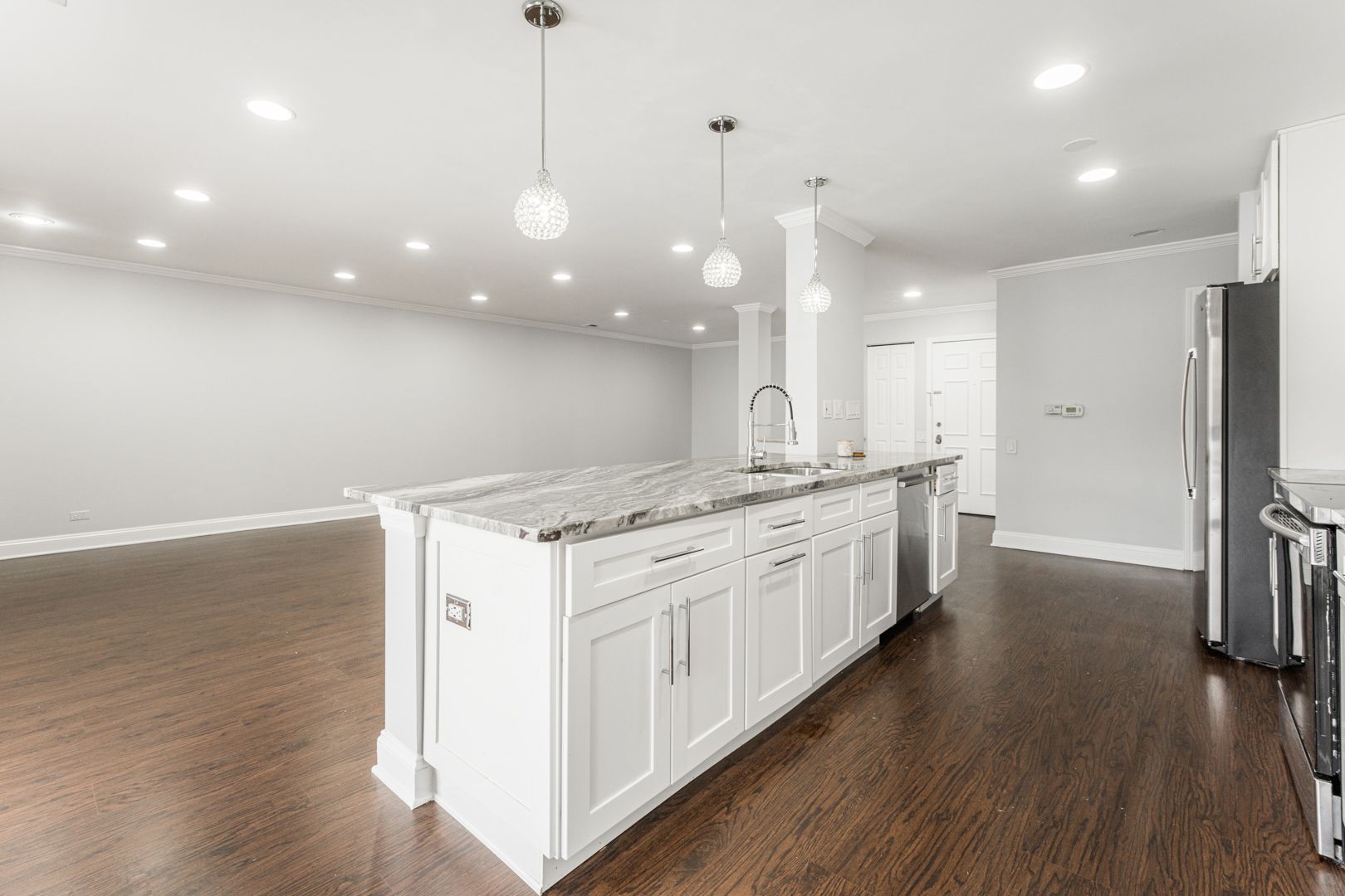 1831 Mission Hills Road, Unit 106 Northbrook, IL 60062 - Photo 10 of 37 a large kitchen with kitchen island a large island wooden floor and stainless steel appliances