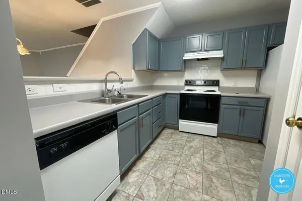 a kitchen with a sink stove and cabinets