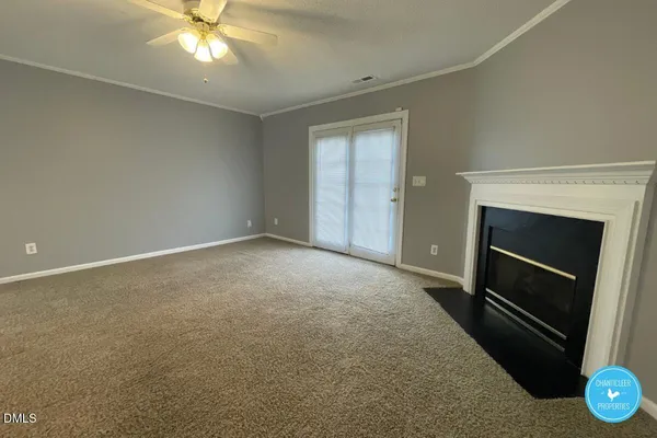 a view of empty room with a fireplace