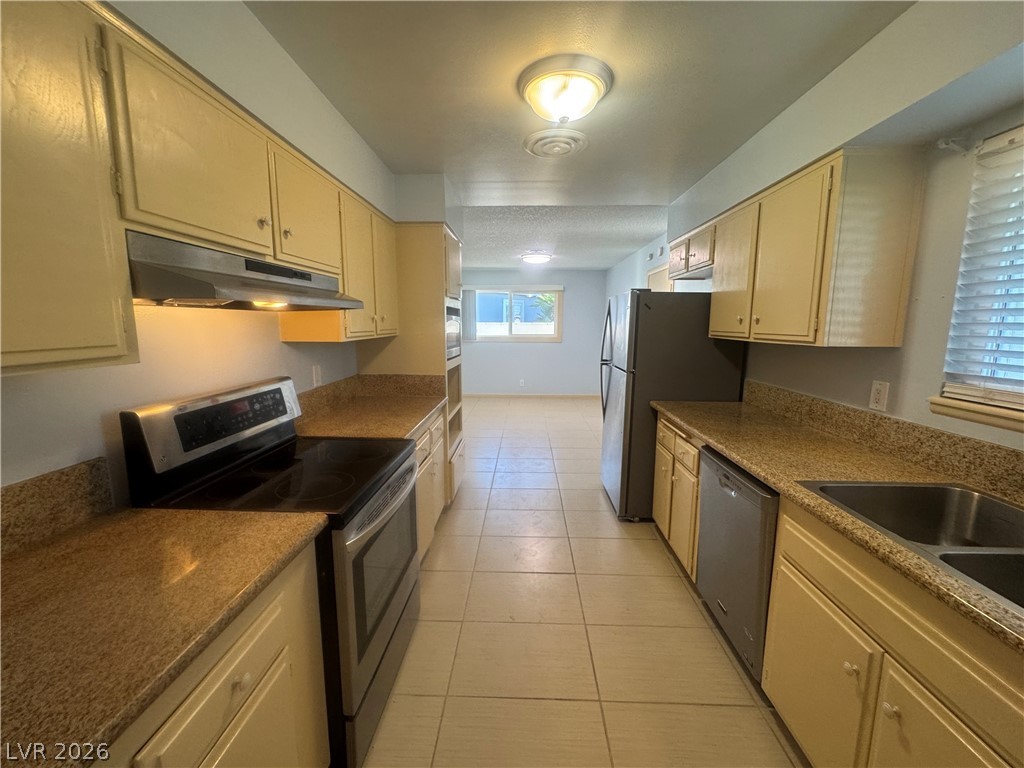 4420 Del Monte Avenue, Unit RENTAL Las Vegas, NV 89102 - Photo 7 of 20 A well-appointed kitchen features ample cabinetry, stone countertops, and modern stainless steel appliances.