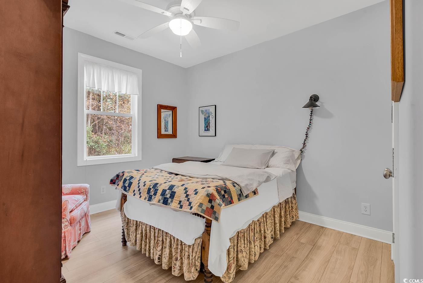 317 Goddard Lane Murrells Inlet, SC 29576 - Photo 21 of 40 Bedroom featuring ceiling fan and light hardwood /