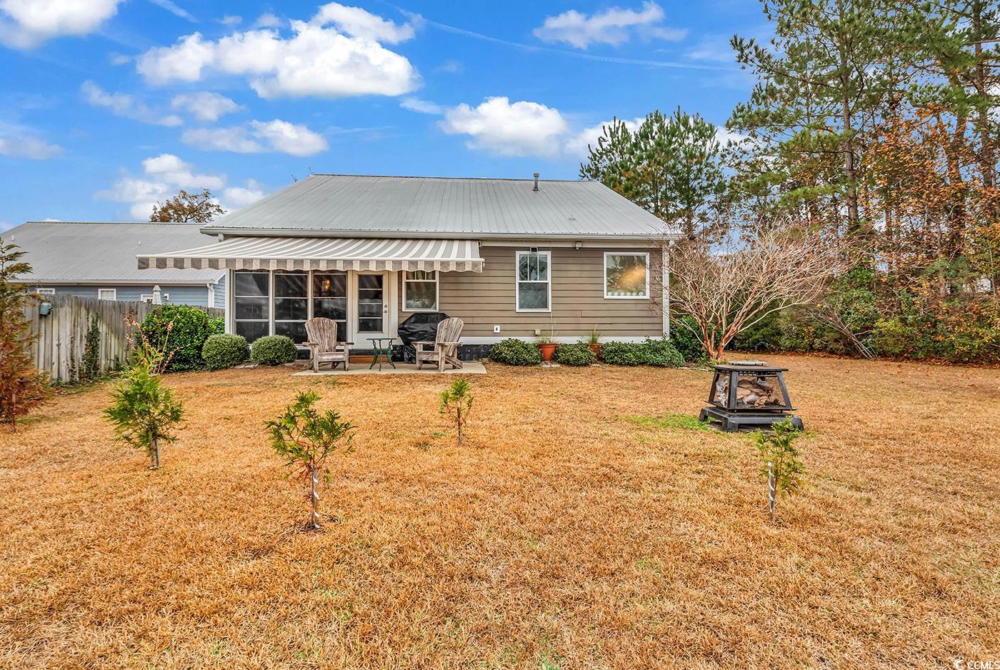 317 Goddard Lane Murrells Inlet, SC 29576 - Photo 34 of 40 Rear view of property featuring a yard, a patio, a