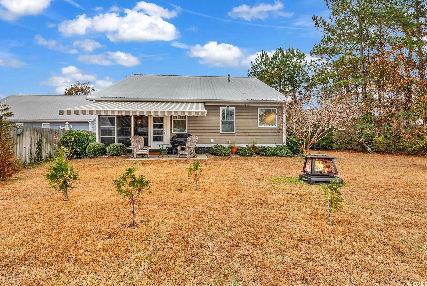 317 Goddard Lane Murrells Inlet, SC 29576 - Photo 35 of 40 Rear view of house featuring a fire pit, a patio a