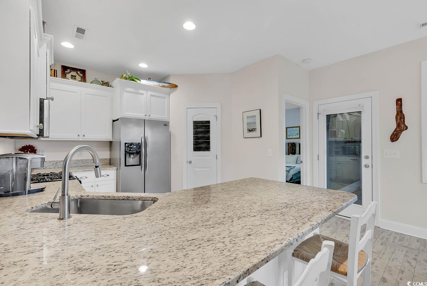 317 Goddard Lane Murrells Inlet, SC 29576 - Photo 7 of 40 Kitchen featuring light stone counters, sink, ligh
