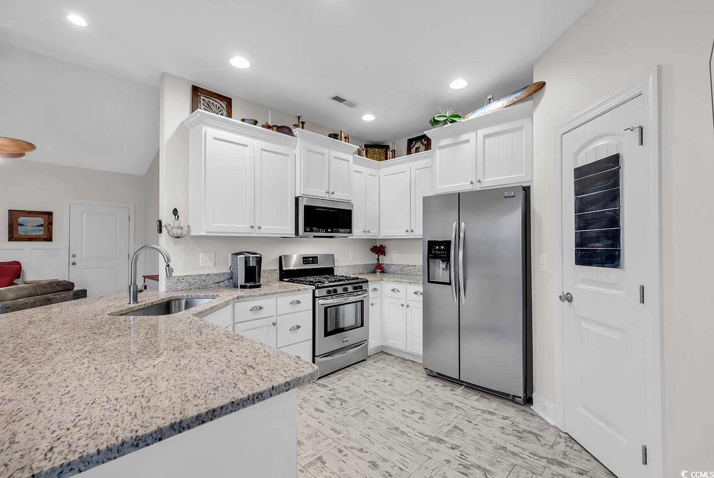 317 Goddard Lane Murrells Inlet, SC 29576 - Photo 8 of 40 Kitchen featuring kitchen peninsula, appliances wi
