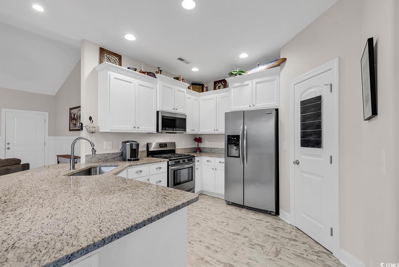 317 Goddard Lane Murrells Inlet, SC 29576 - Photo 9 of 40 Kitchen with sink, light stone counters, kitchen p