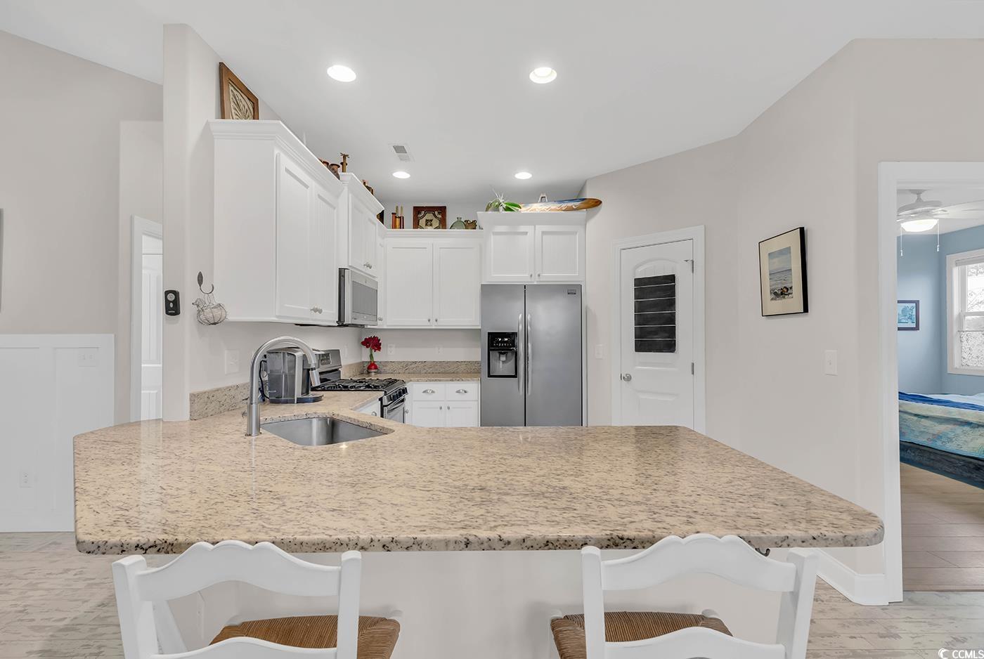 317 Goddard Lane Murrells Inlet, SC 29576 - Photo 10 of 40 Kitchen featuring kitchen peninsula, appliances wi