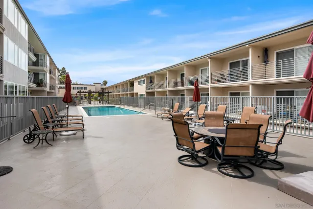a view of a patio with table and chairs and a barbeque