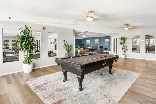 a living room with patio furniture and a wooden floor