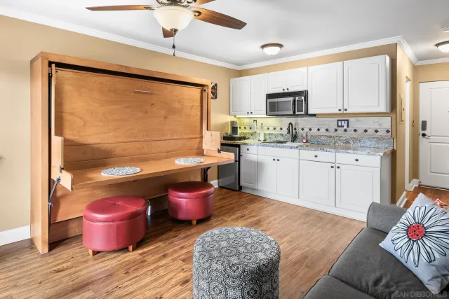 a kitchen with a stove a sink and cabinets