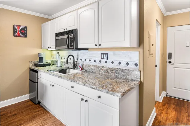 a kitchen with sink cabinets and microwave
