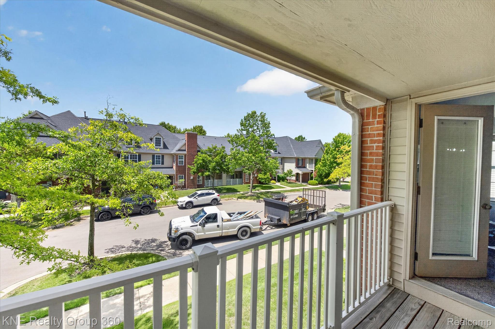 4077 Berkeley Avenue Canton, MI 48188 - Photo 27 of 32 Private balcony featuring wood-finish flooring, white railing, and exterior brick accents