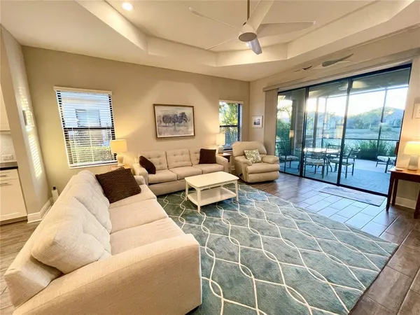 a living room with furniture and a floor to ceiling window