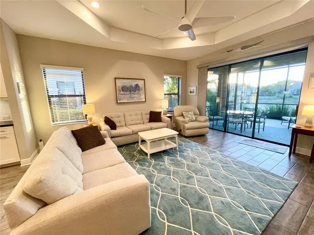 a living room with furniture and a floor to ceiling window
