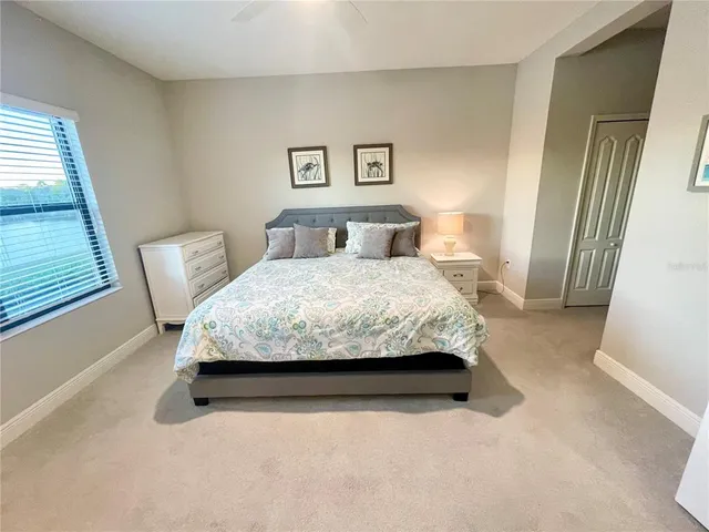 a bedroom with a bed chair and a window