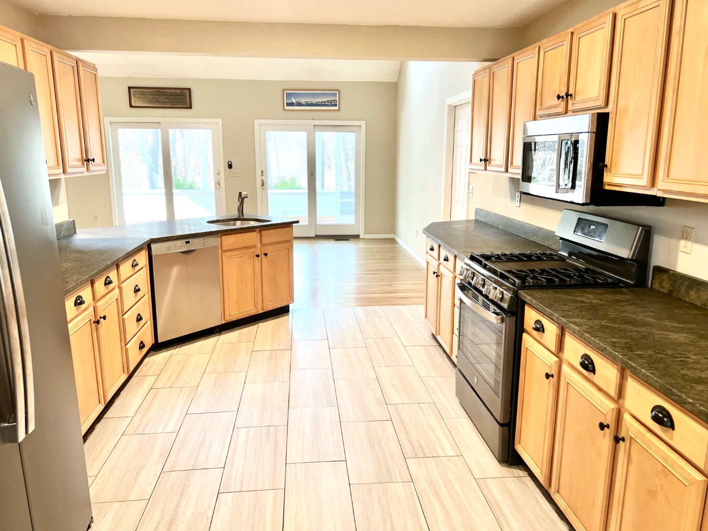 209 Cove Road Vineyard Haven, MA 02568 - Photo 22 of 81 a kitchen with stainless steel appliances granite countertop a stove a sink and a microwave