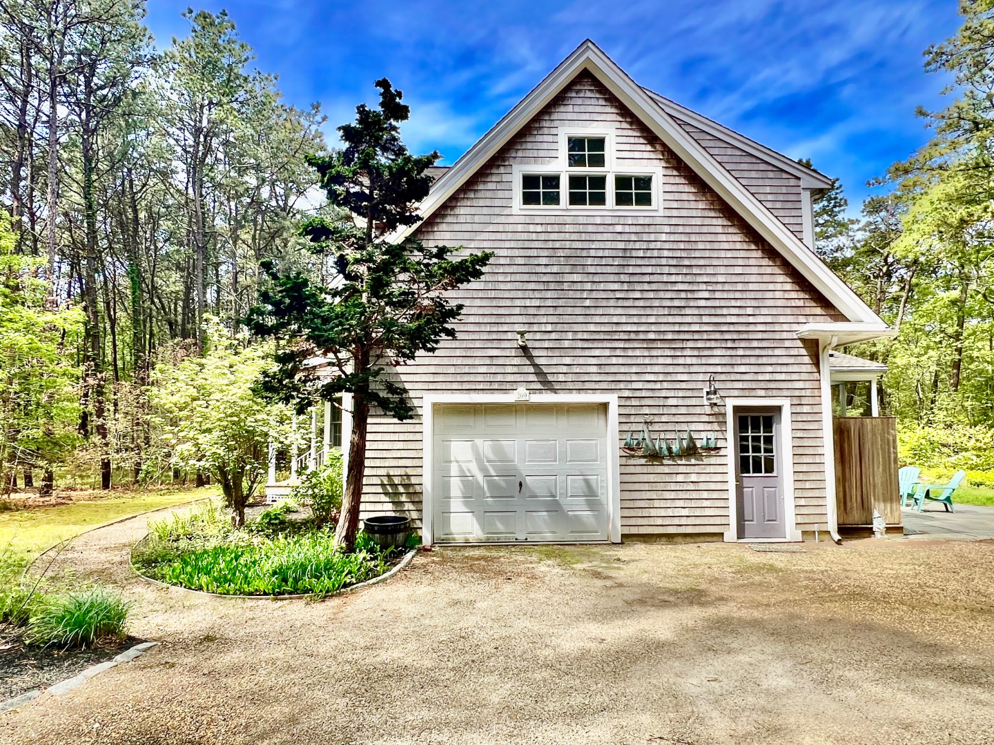209 Cove Road Vineyard Haven, MA 02568 - Photo 6 of 81 a front view of a house with a yard and garage