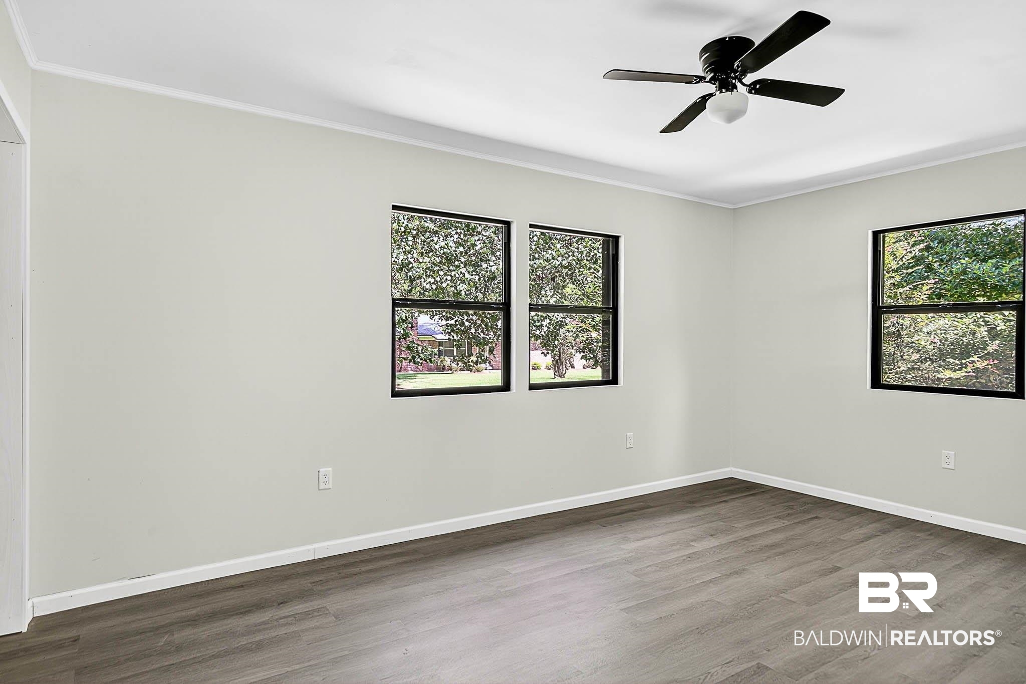 101 Terry Avenue Brewton, AL 36426 - Photo 37 of 48 Spare room with dark wood-style flooring, crown molding, and ceiling fan