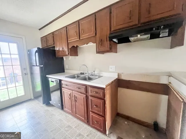 a kitchen with stainless steel appliances granite countertop a refrigerator and a sink