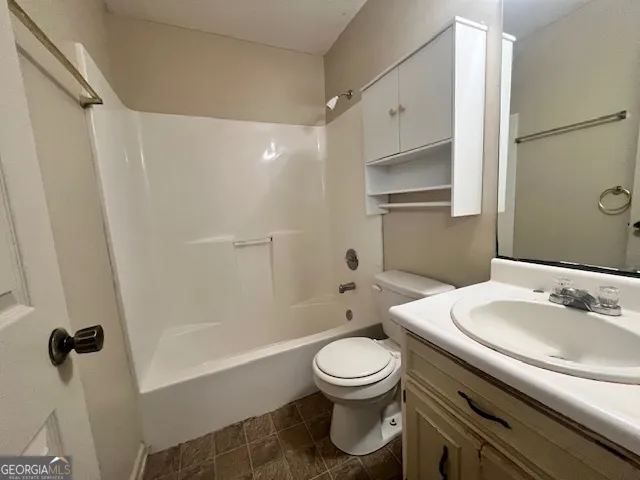a bathroom with a toilet sink and shower