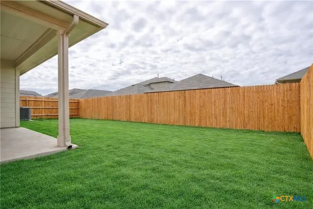 a view of a backyard with plants and a garden
