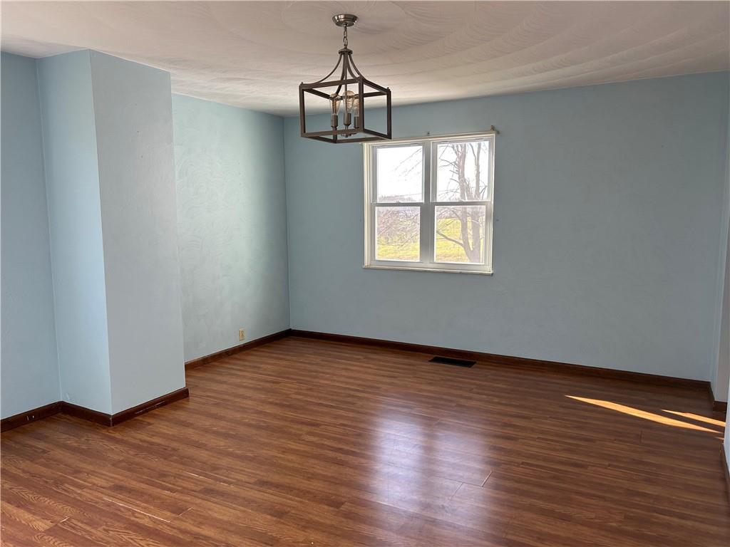 556 Bonniebrook Road Butler, PA 16002 - Photo 11 of 36 a view of an empty room with wooden floor and a window