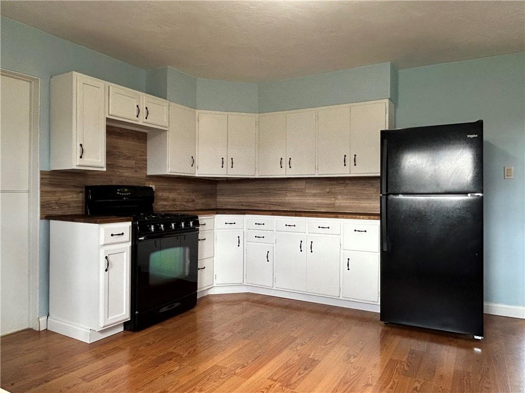 556 Bonniebrook Road Butler, PA 16002 - Photo 15 of 36 a kitchen with granite countertop white cabinets and stainless steel appliances