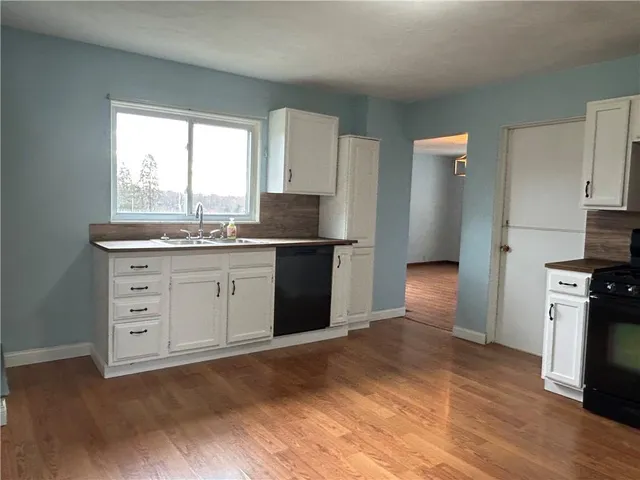 a kitchen with a stove a sink and a refrigerator
