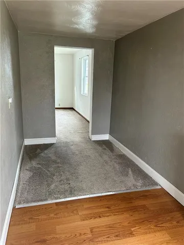 an empty room with wooden floor