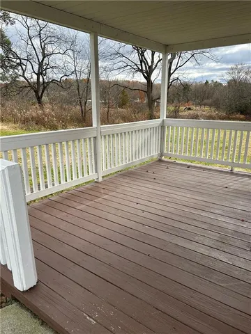 a view of a balcony with wooden floor