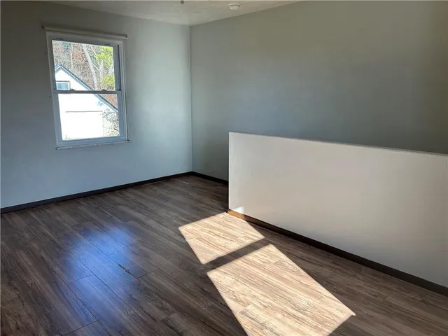 an empty room with wooden floor