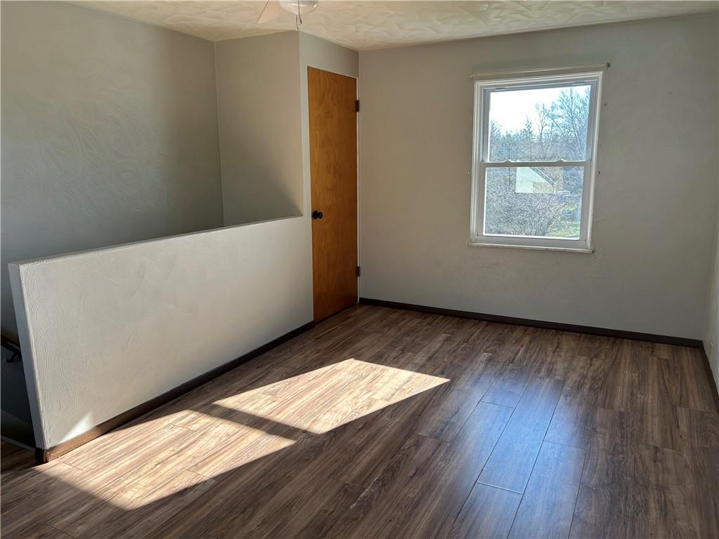 556 Bonniebrook Road Butler, PA 16002 - Photo 30 of 36 an empty room with wooden floor and windows